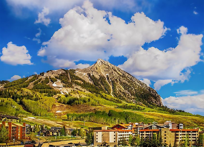 Crested Butte Colorado USA. Ski lodges sit at bottom on mountain in springtime.