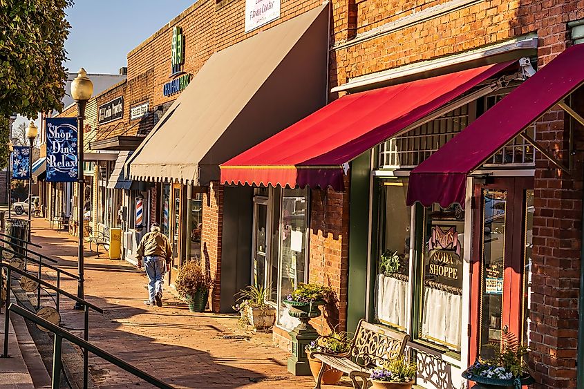 Pittsboro, North Carolina An Old Man Bent With Age Walks Toward a Barber Shop in Downtown Pittsboro.