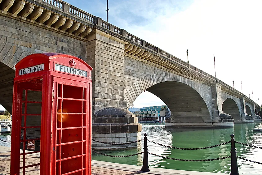 Editorial Photo Credit: EWY Media via Shutterstock. Lake Havasu City, Arizona: An iconic English red phone booth and the London Bridge. The bridge was purchased from London and reconstructed in Arizona in 1971 to bring tourism to the area.