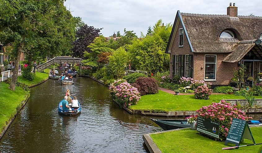 Sightseeing boating trip in a canal in Giethoorn, Netherlands.