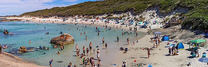 People enjoying the pristine turquoise waters and white sandy beach at Greens Pool in Denmark, Western Australia