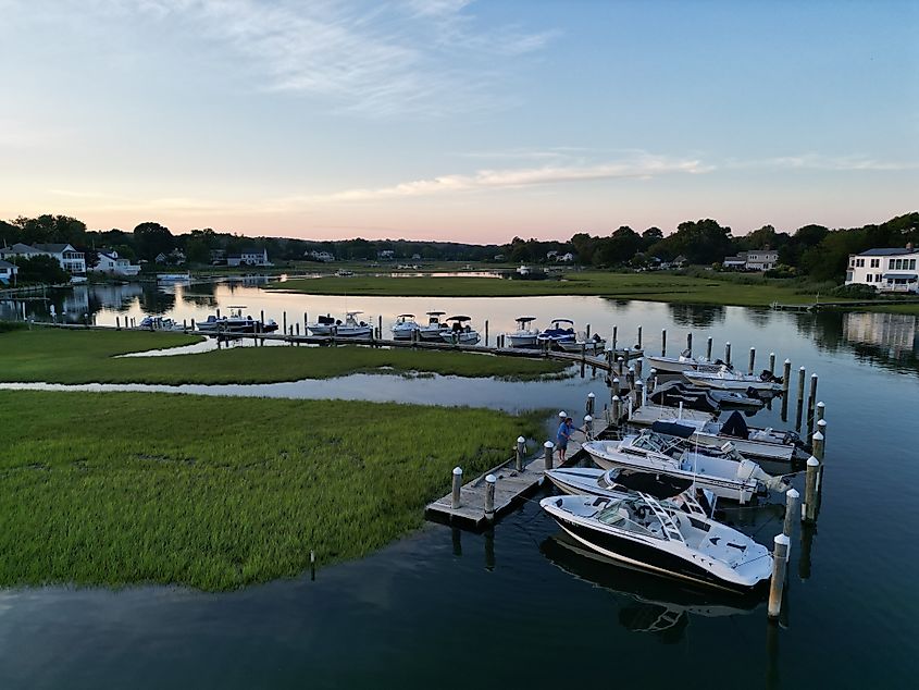 Sunset view of boats and houses along the coast in Old Saybrook, Connecticut.