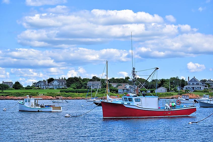 Lighthouse standing at the edge of the water near the harbor in Little Compton, Rhode Island.