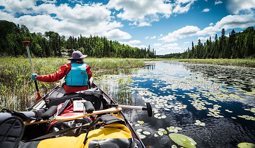 Canoeing over remote lakes in Ely, Minnesota.