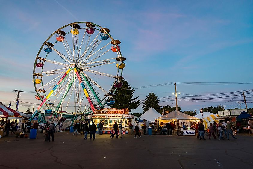 Visitors enjoying the festivities, theme park attractions, and vendors at the fair in Fryeburg, Maine, USA.