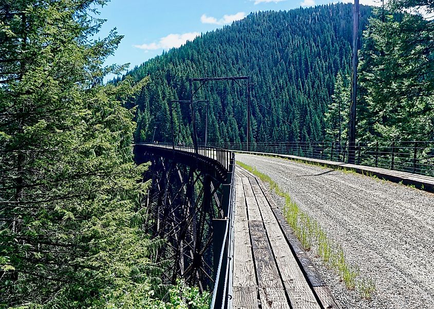 Cyclists on a trestle bridge along the Route of the Hiawatha.