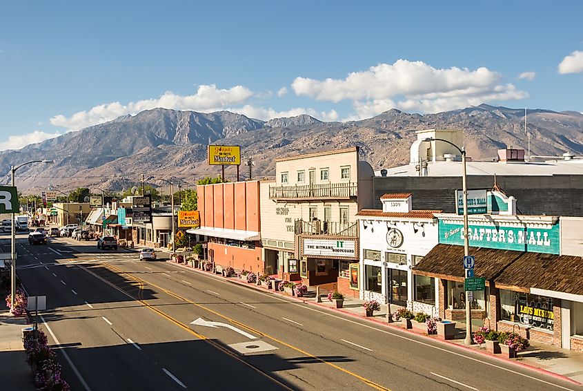 Businesses lined along downtown Bishop with views of the scenic Sierra Nevada mountains in California.