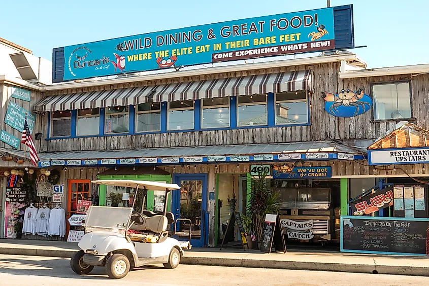 Shops and restaurants along the Gulf of Mexico waterfront in Cedar Key, Florida.
