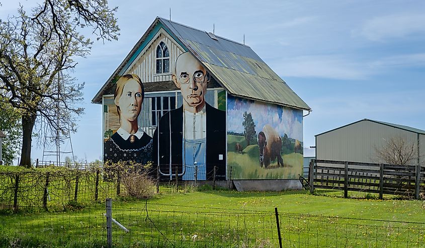 American Gothic Barn, barn-sized rendition of Grant Wood's most famous, and most parodied, painting of farming couple and nearby Iowa gothic farm house.