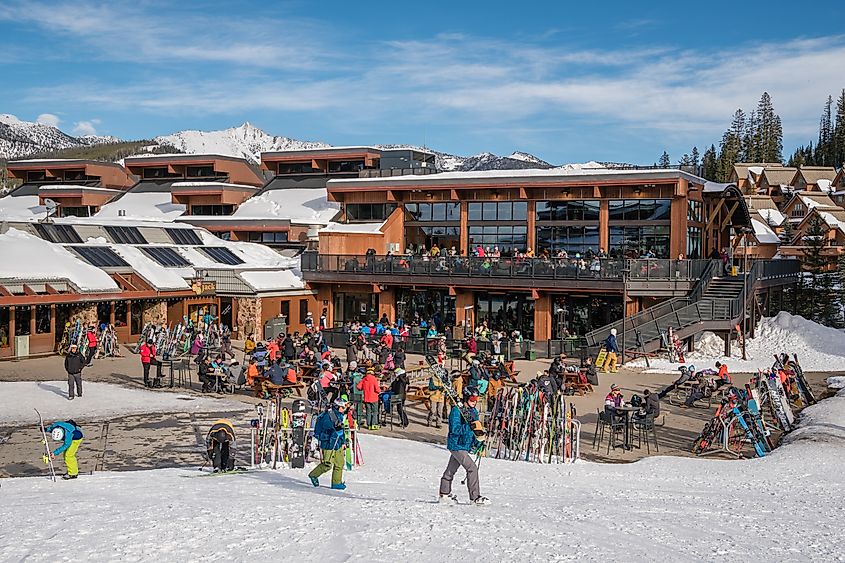 Crowd of people preparing to ski near ski lodge at famous western US ski resort in Big Sky, Montana. Editorial credit: Heidi Besen / Shutterstock.com