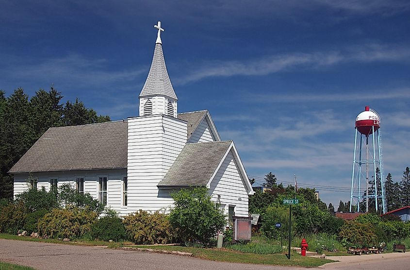 Former church, now Northern Treasures antique shop, and water tower at the corner of Brown and Spruce Streets in Pequot Lakes, Minnesota