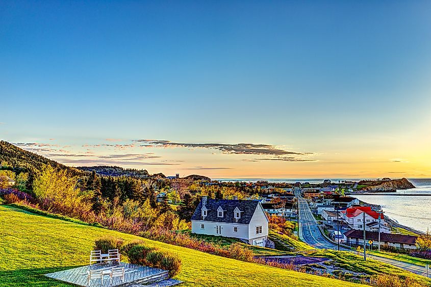 Hotel chairs on hill during sunrise in Perce, Gaspe Peninsula, Quebec