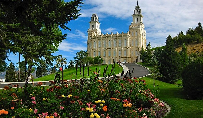 Manti LDS Mormon Temple with flowers clouds trees blue sky