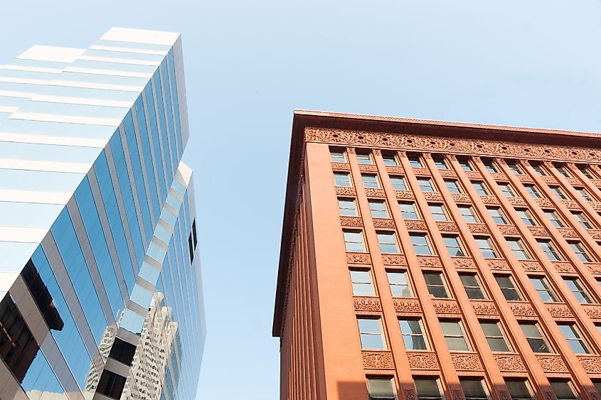Historic Wainwright Building designed in Palazzo style contrasts with mirror glass modern structure opposite.