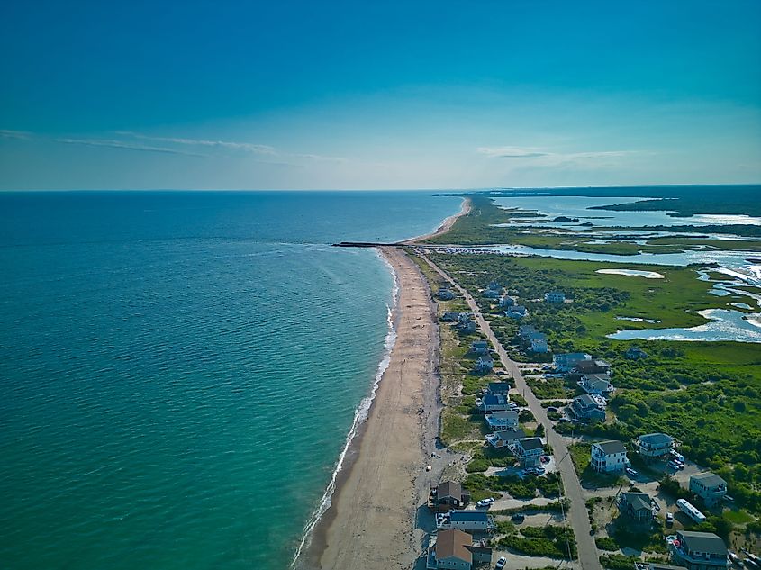 Sandy beach in Charlestown, Rhode Island, with gentle waves and a clear horizon.