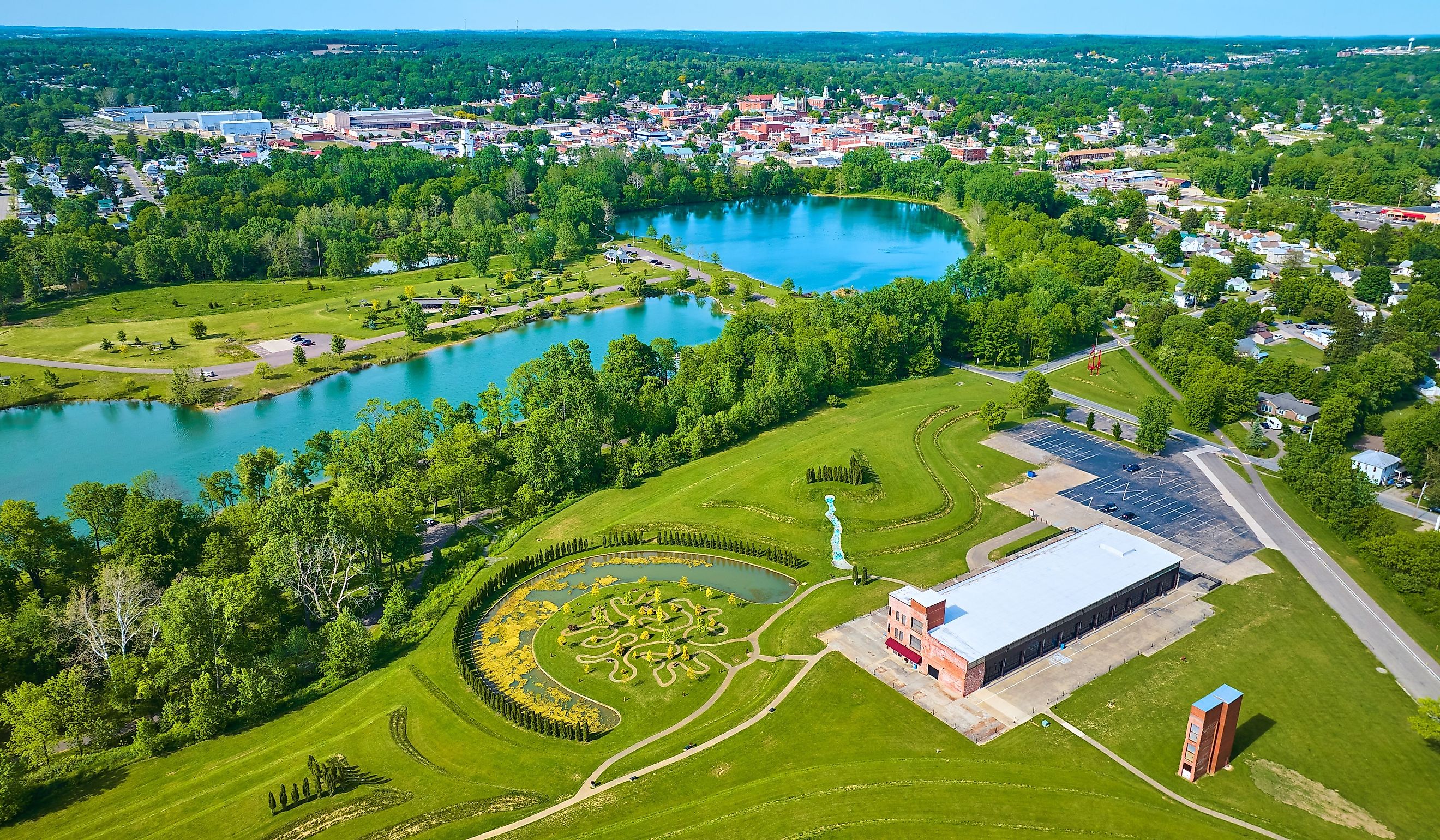 Turquoise pond water in distant summertime aerial over Mount Vernon and Ariel Foundation Park, Ohio. 