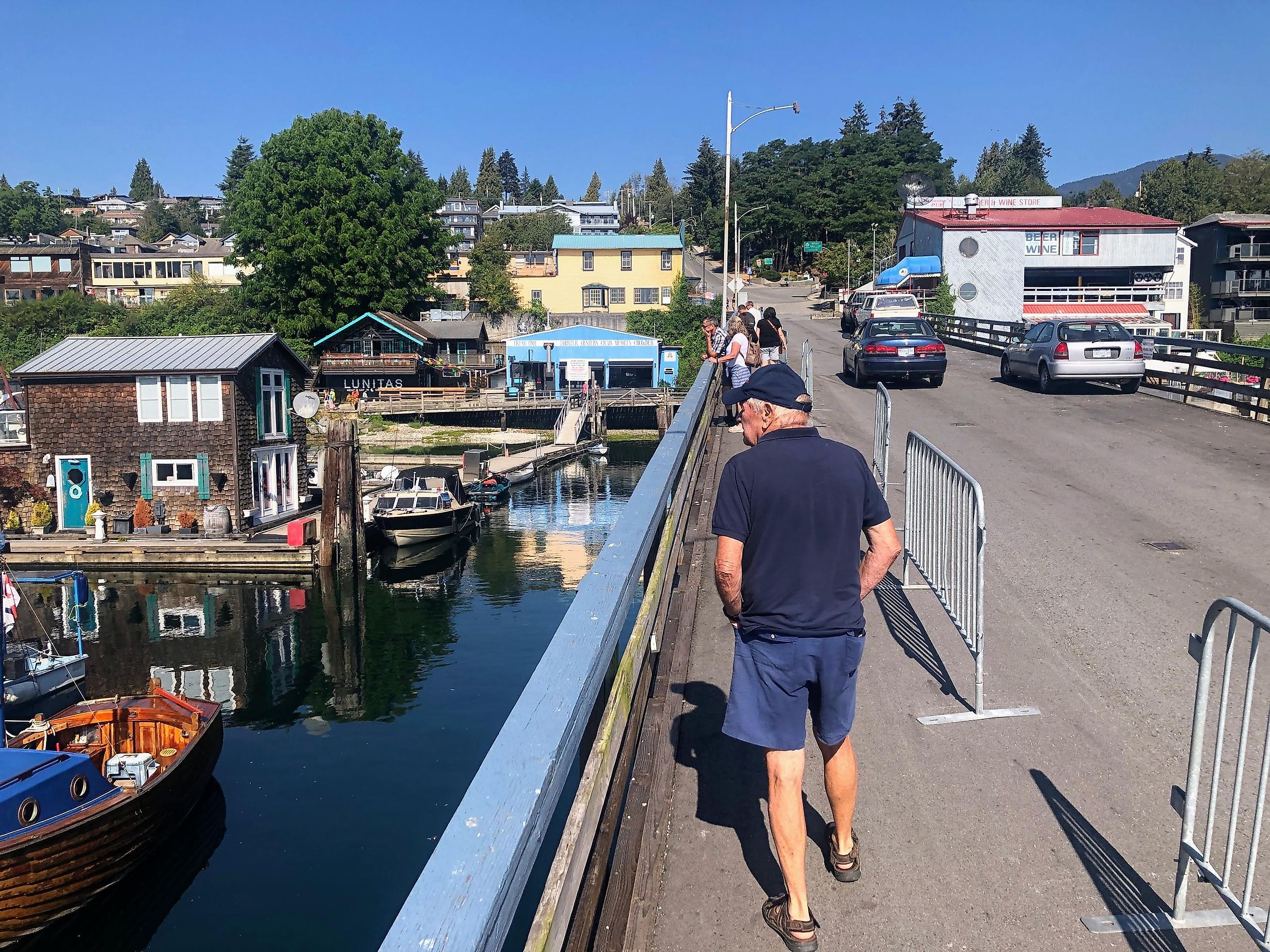 A man walking through the beautiful downtown of Gibsons, surrounded by shops and restaurants, along the sunshine coast, British Columbia, via Chris Babcock / iStock.com