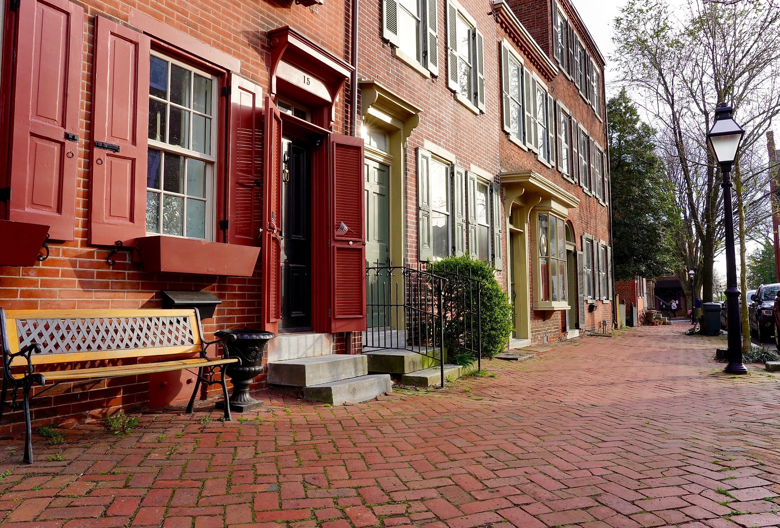 The historic New Castle Green in New Castle, Delaware, surrounded by colonial-era homes, public buildings, roads, and modern-day statues and historic markers. Editorial credit: George Wirt / Shutterstock.com