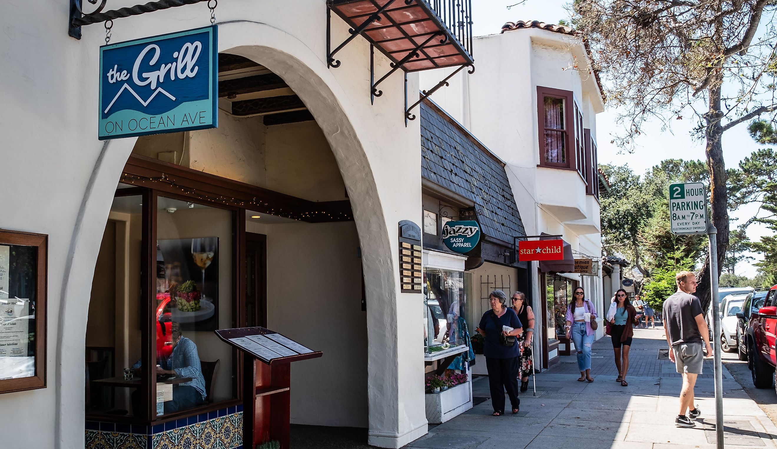 Pedestrians near The Grill on Ocean Avenue, the main street in Carmel-by-the-Sea, via Brycia James / iStock.com