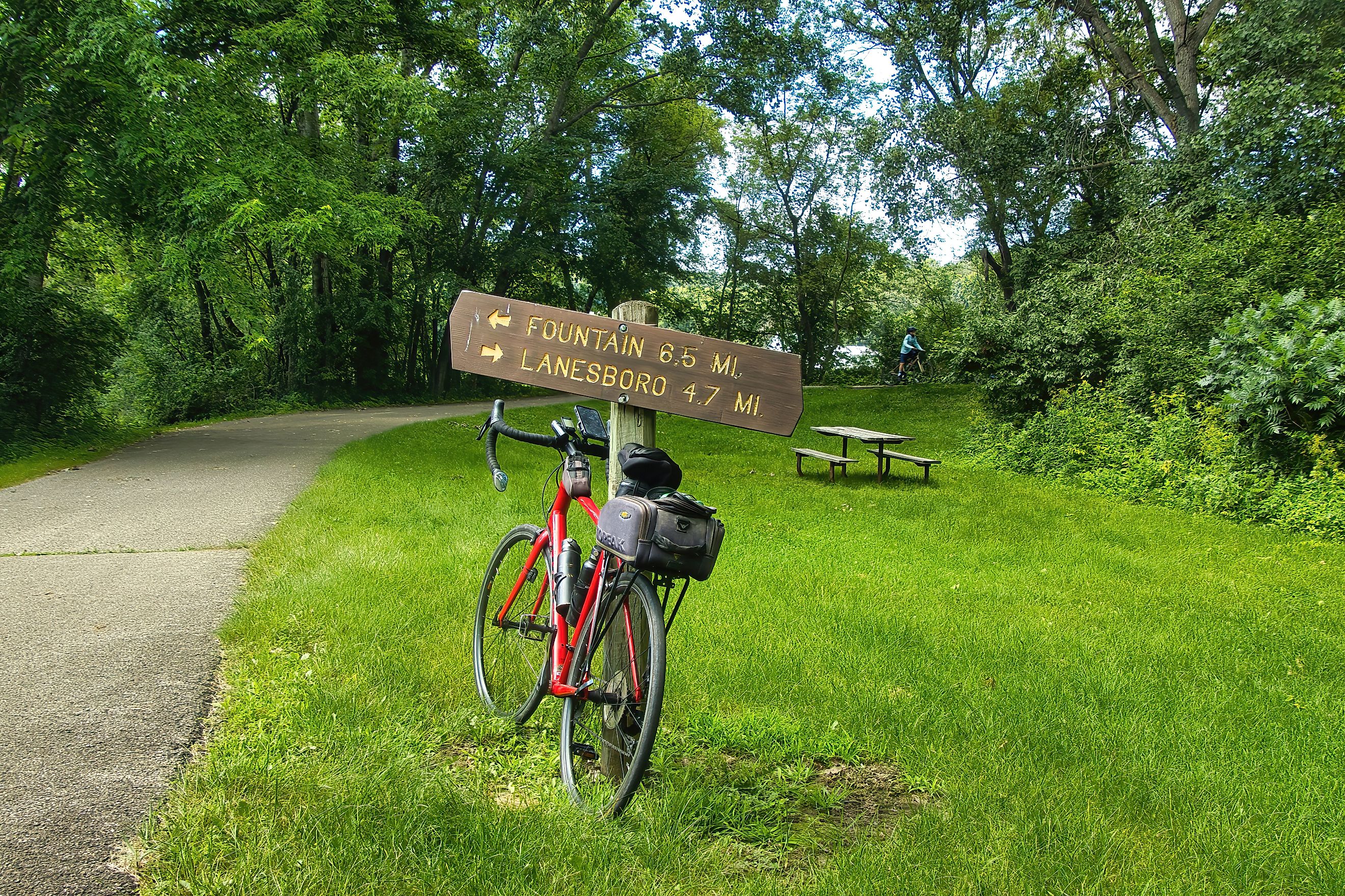 A bike leaning against the mile marker along the Root River and Harmony-Preston Valley Trails near Lanesboro, Minnesota. Editorial credit: Dave Jonasen / Shutterstock.com