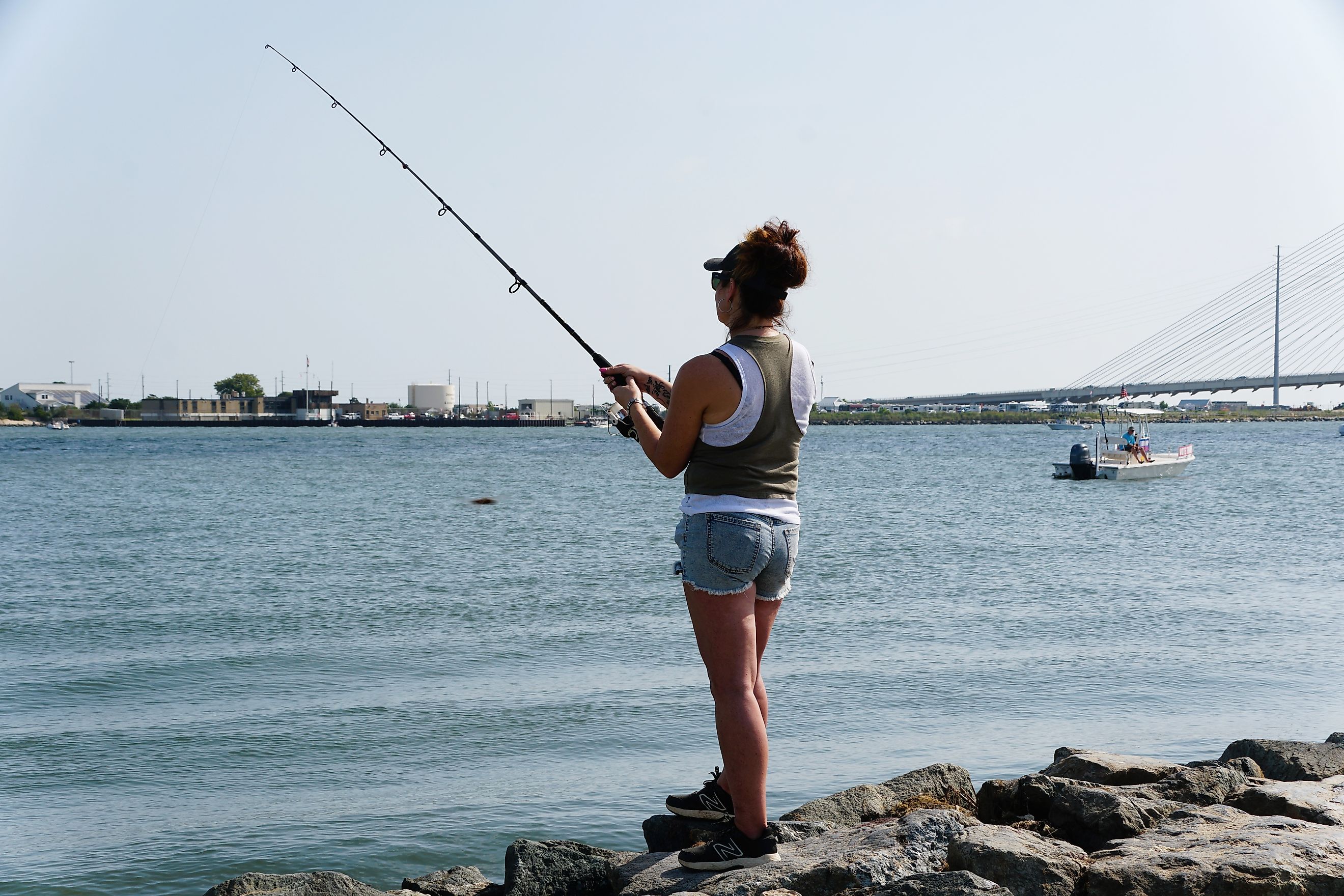 Outdoorsman casts her line on Bethany Beach in Delaware, USA