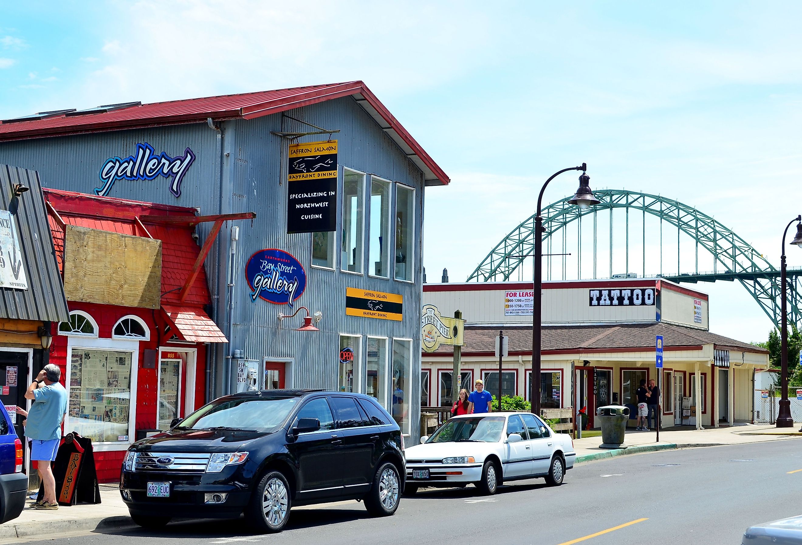 Front street view of Newport, Oregon fishing town with Yaquina Bay bridge in the background.