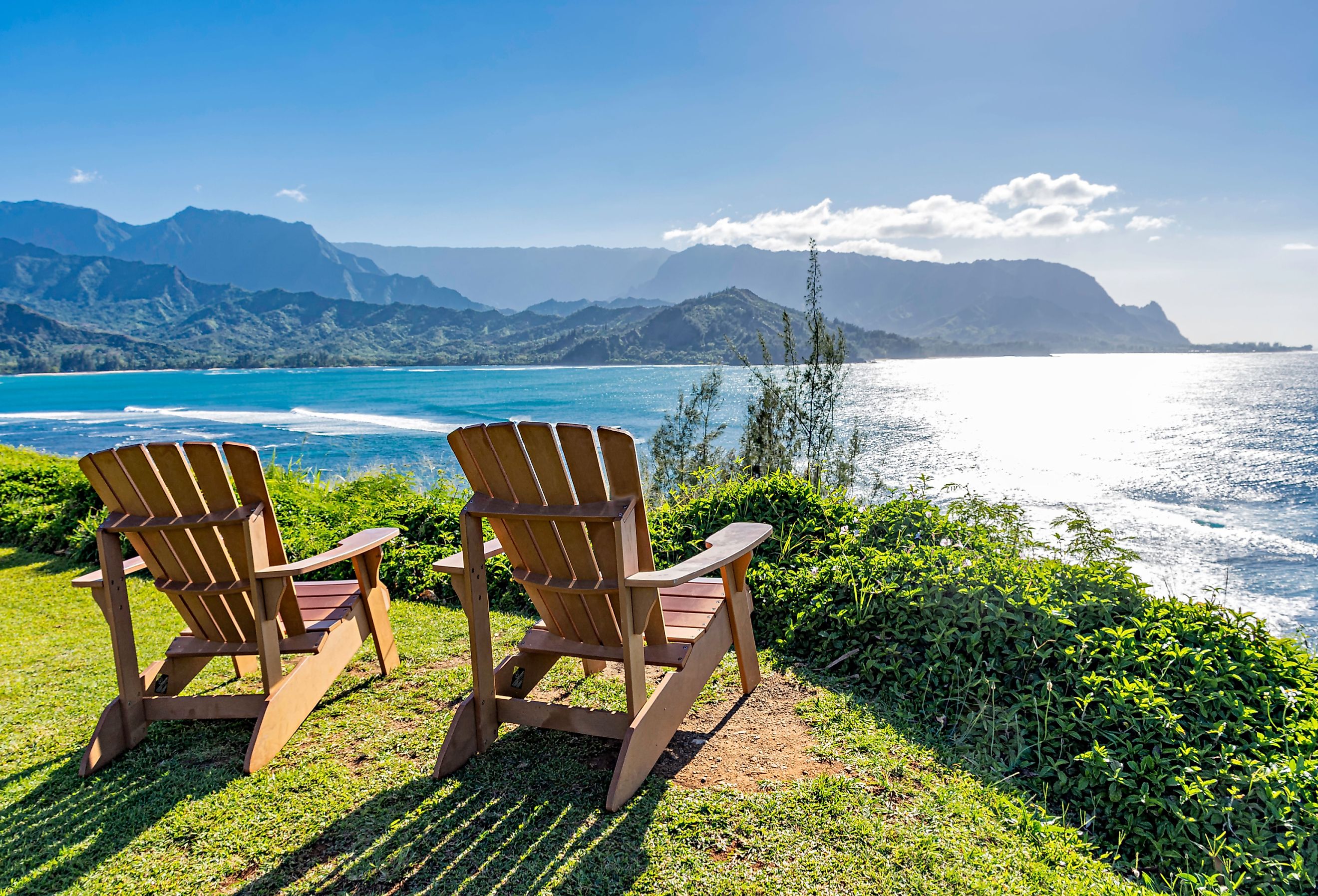  Lounge chairs overlooking Hanalei Bay and the Na Pali coast Princeville Kauai Hawaii USA in the late afternoon sun