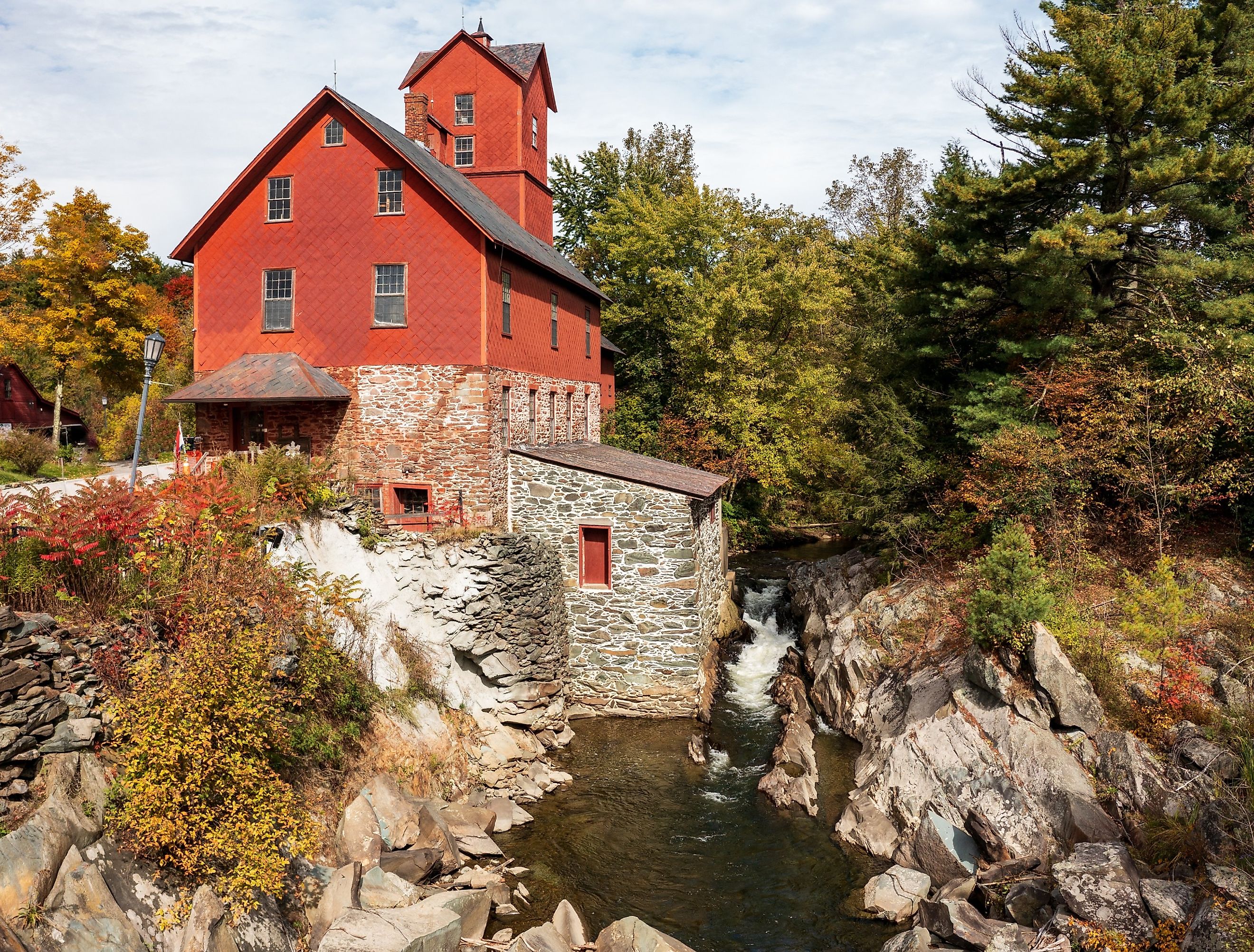 Old Red Mill by the creek in Jericho, Vermont during the fall.