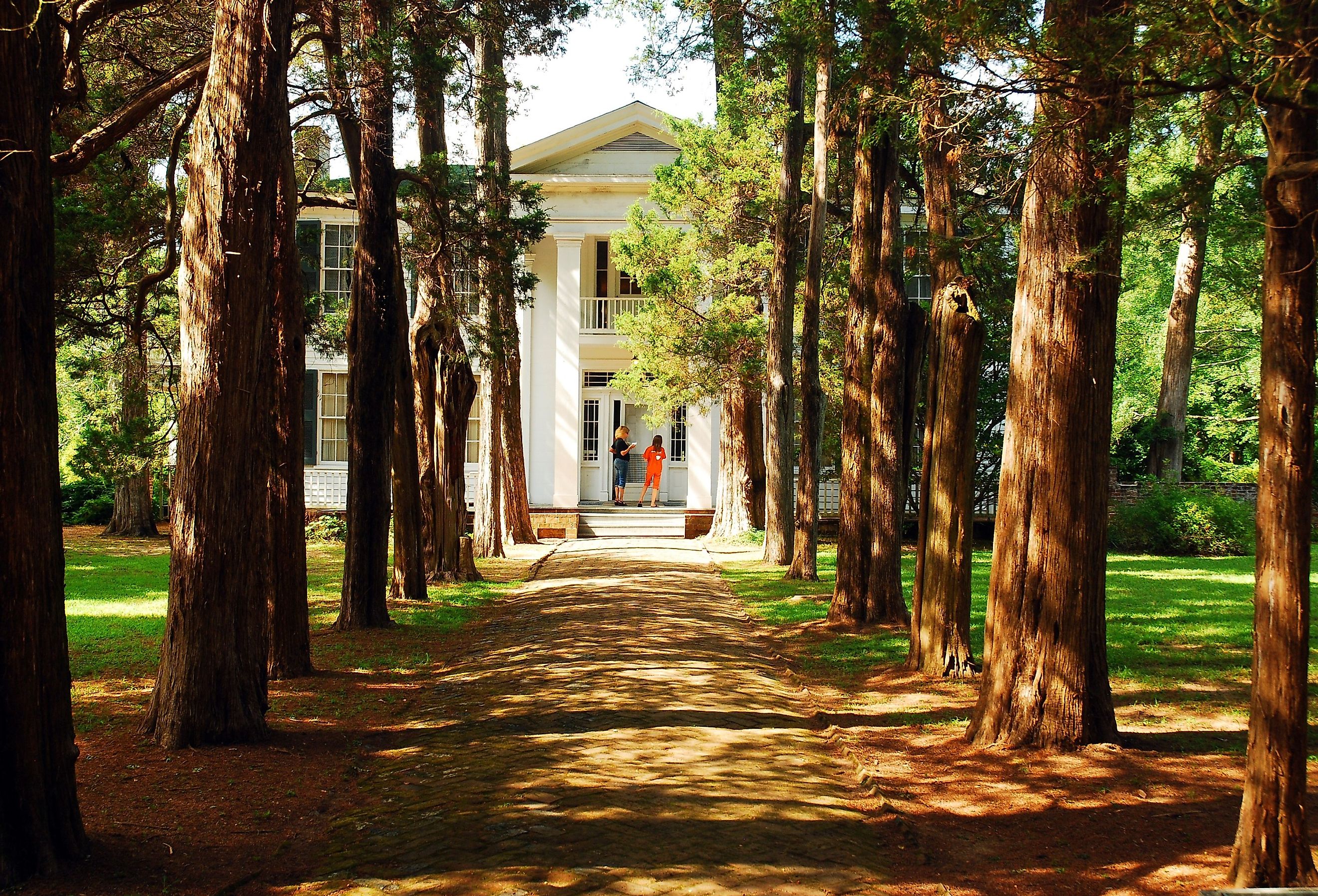 Two visitors outside Rowan Oak, William Faulkner's home in Oxford, Mississippi. Image credit James Kirkikis via Shutterstock.