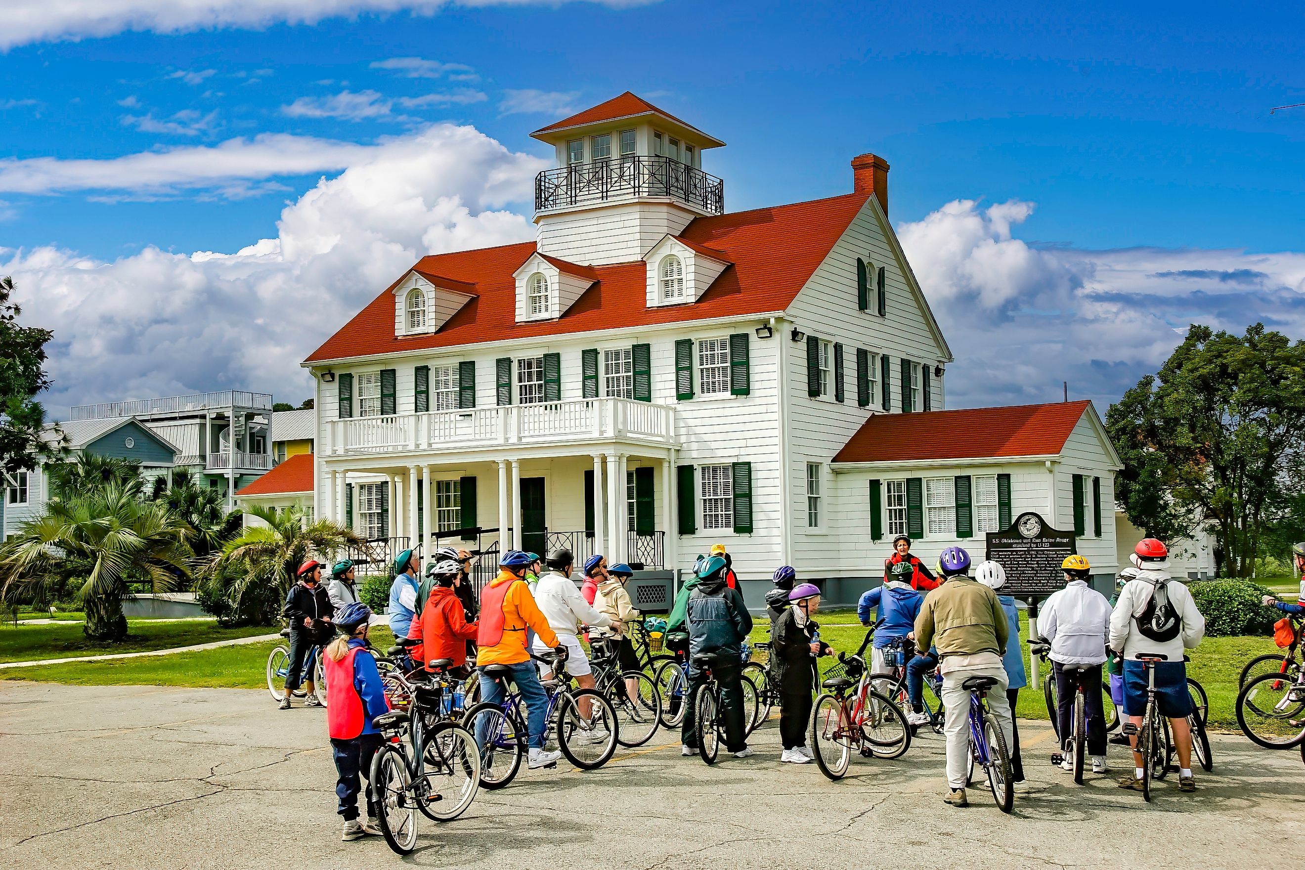 St. Simons Island, Georgia: Leader of a bicycle tour group giving instruction in front of the St. Simons Island Light, a lighthouse located on the southern tip of the island. Editorial credit: Bob Pool / Shutterstock.com