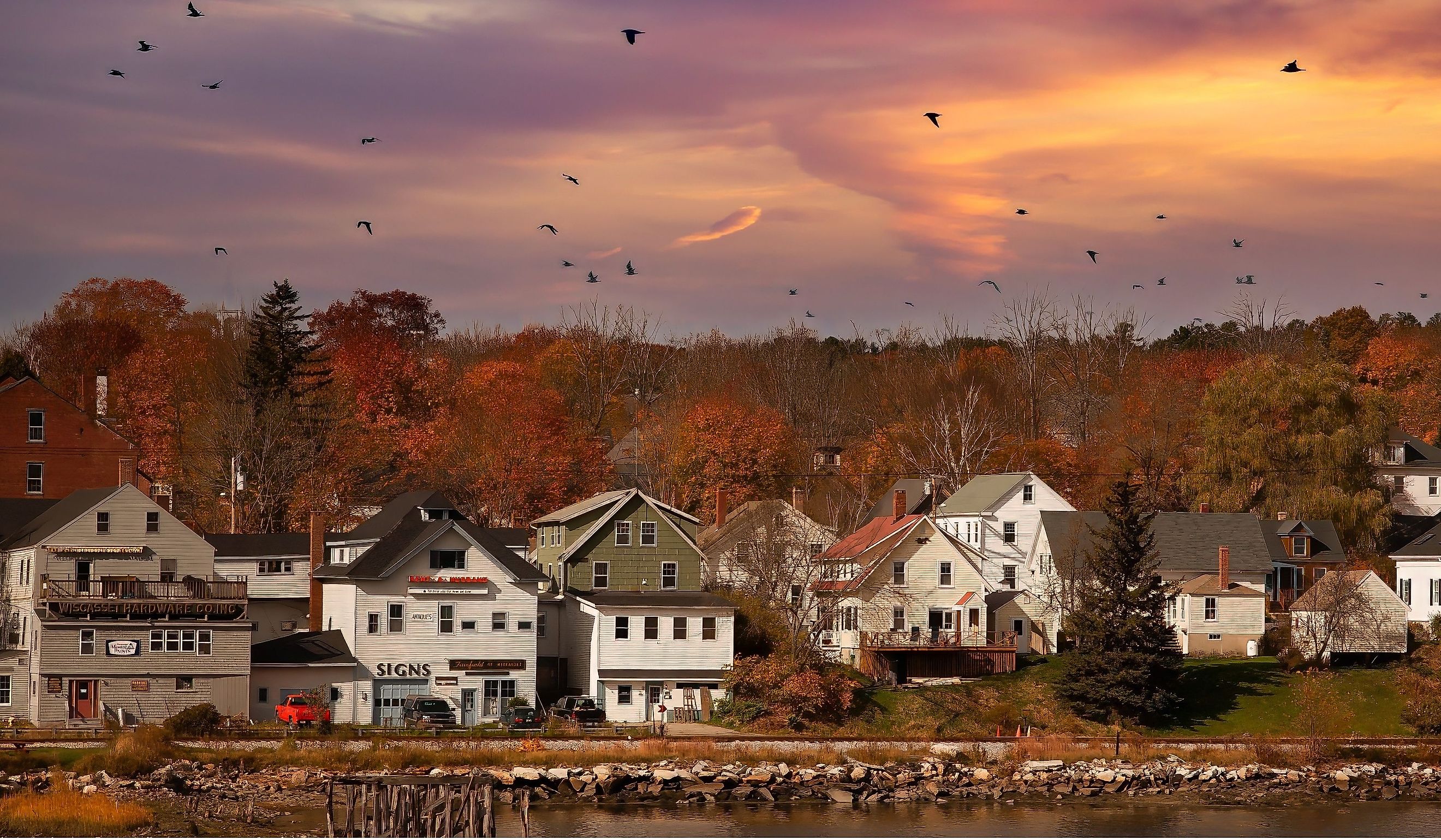 Waterfront homes and businesses in Wiscasset, Maine, at sunset. Editorial credit: Bob Pool / Shutterstock.com