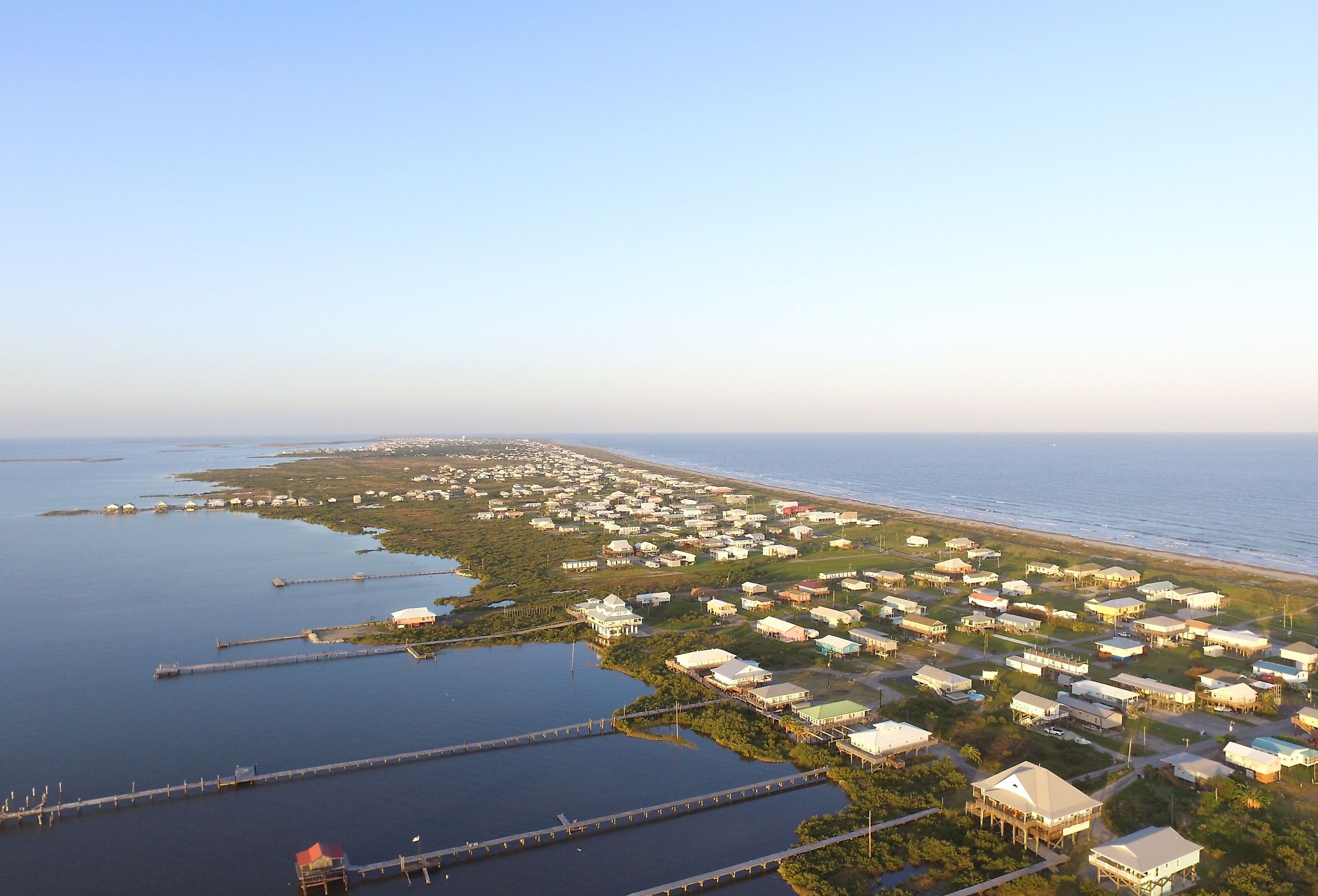 Stilt houses with long docks in the low-lying town of Grand Isle, Louisiana.