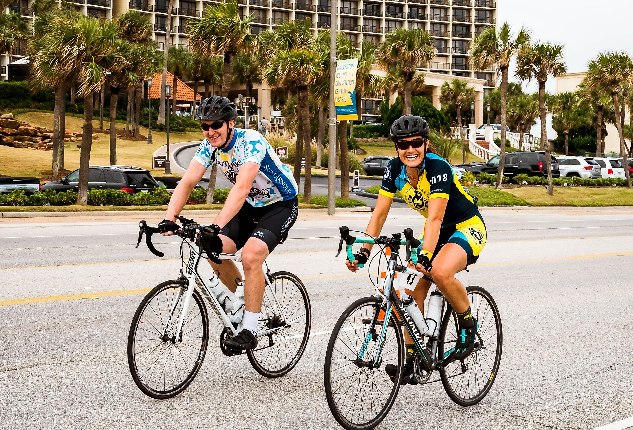 Cyclists ride along the seawall while participating in the Bike Around The Bay Benefit ride in Galveston, Texas. Image credit Mark Taylor Cunningham via Shutterstock