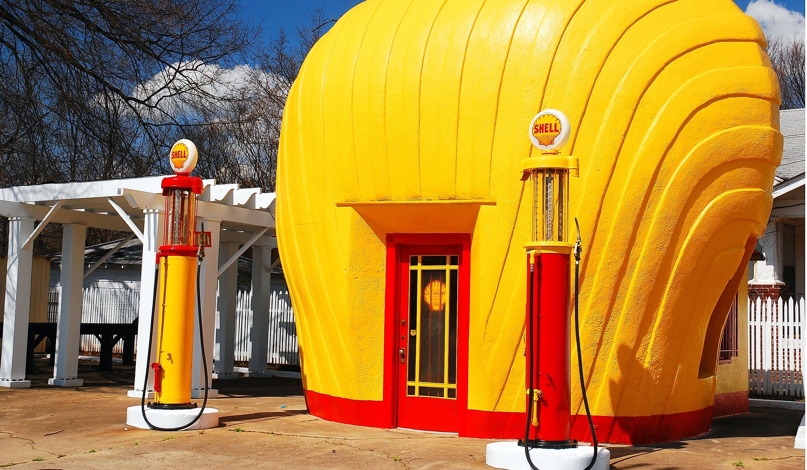 A vintage Shell gas station is shaped like a yellow scallop shell. Editorial credit: James Kirkikis / Shutterstock.com