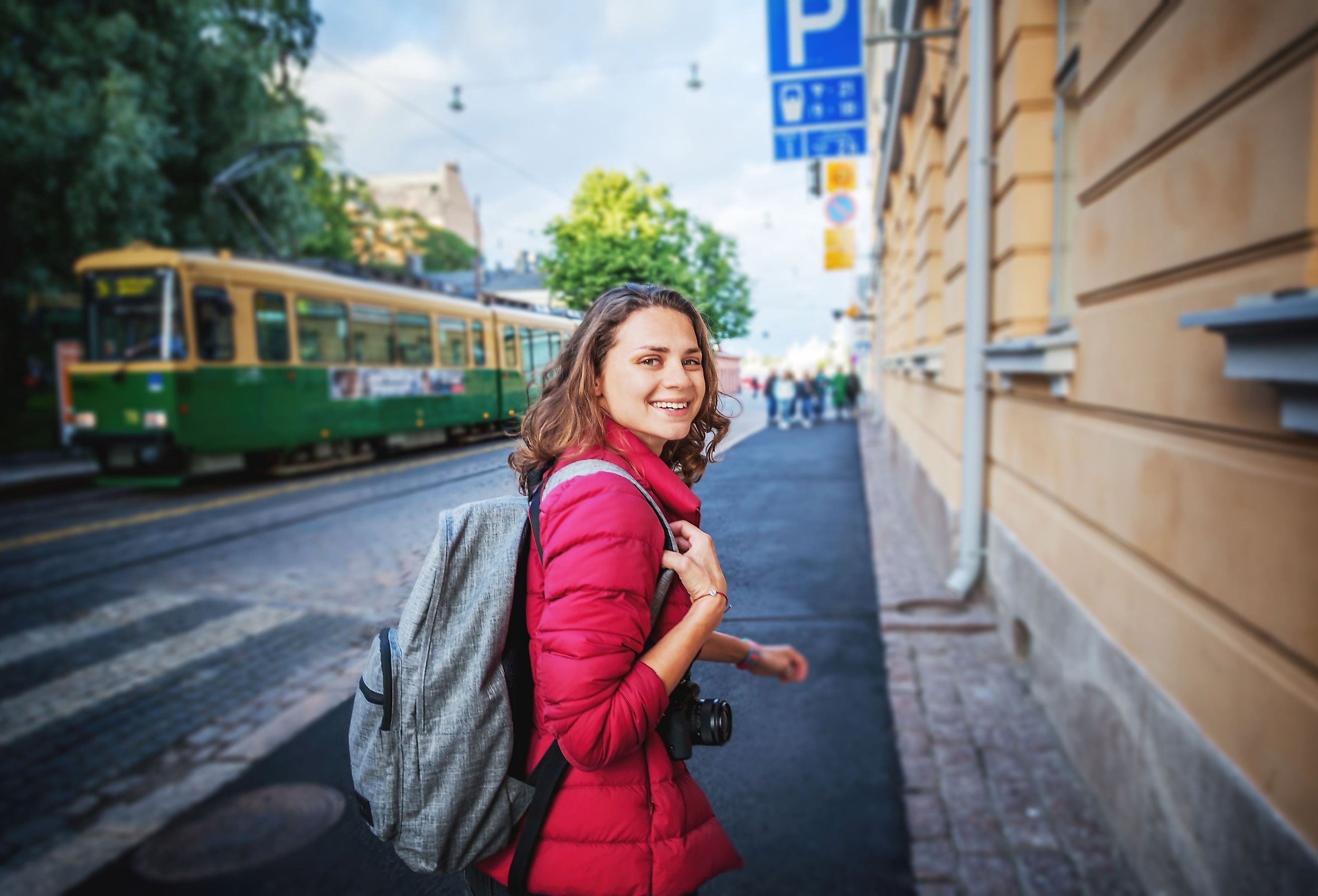 Happy woman looking back in Helsinki, Finland, the happiest country in the world.