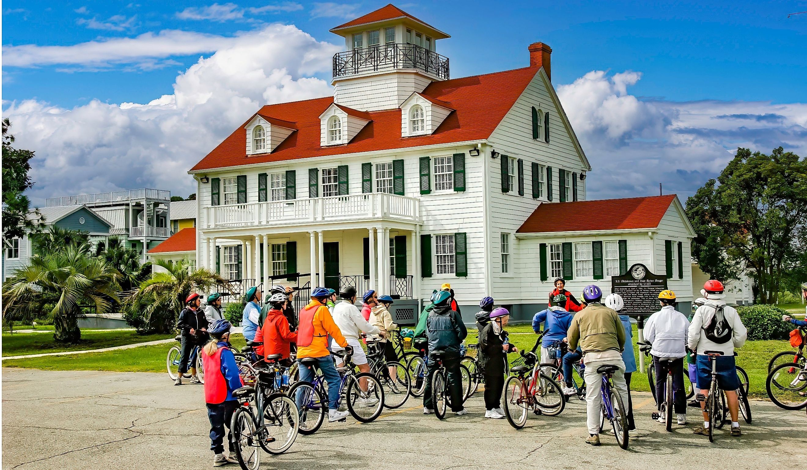 The leader of a bicycle tour group giving instruction in front of the St. Simons Island Light. Editorial credit: Bob Pool / Shutterstock.com