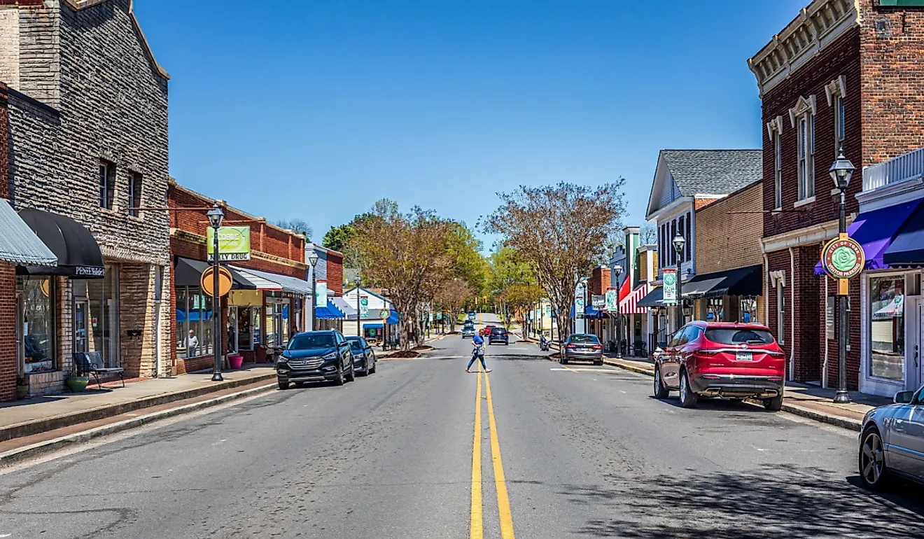 York, South Carolina: Wide angle view down North Congress Street on a sunny, blue sky, spring day. Woman crossing street.