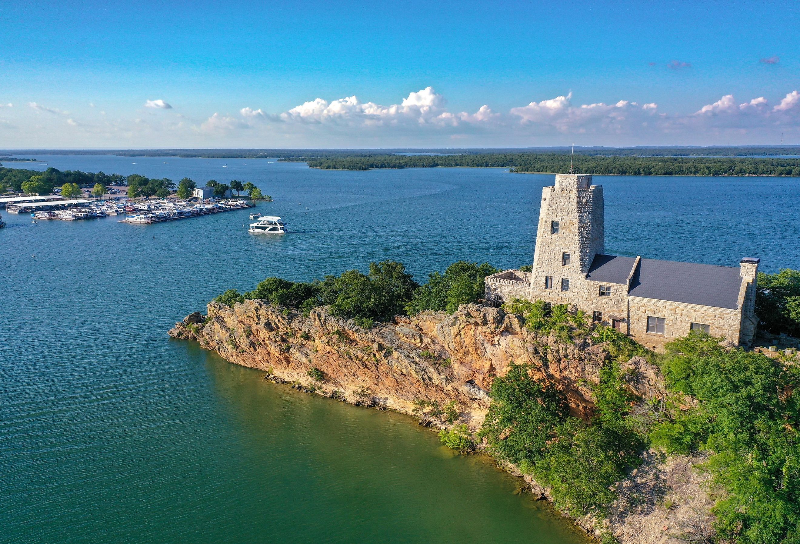 Overlooking Tucker Tower in Lake Murray State Park on a summer day with a houseboat in the distance.