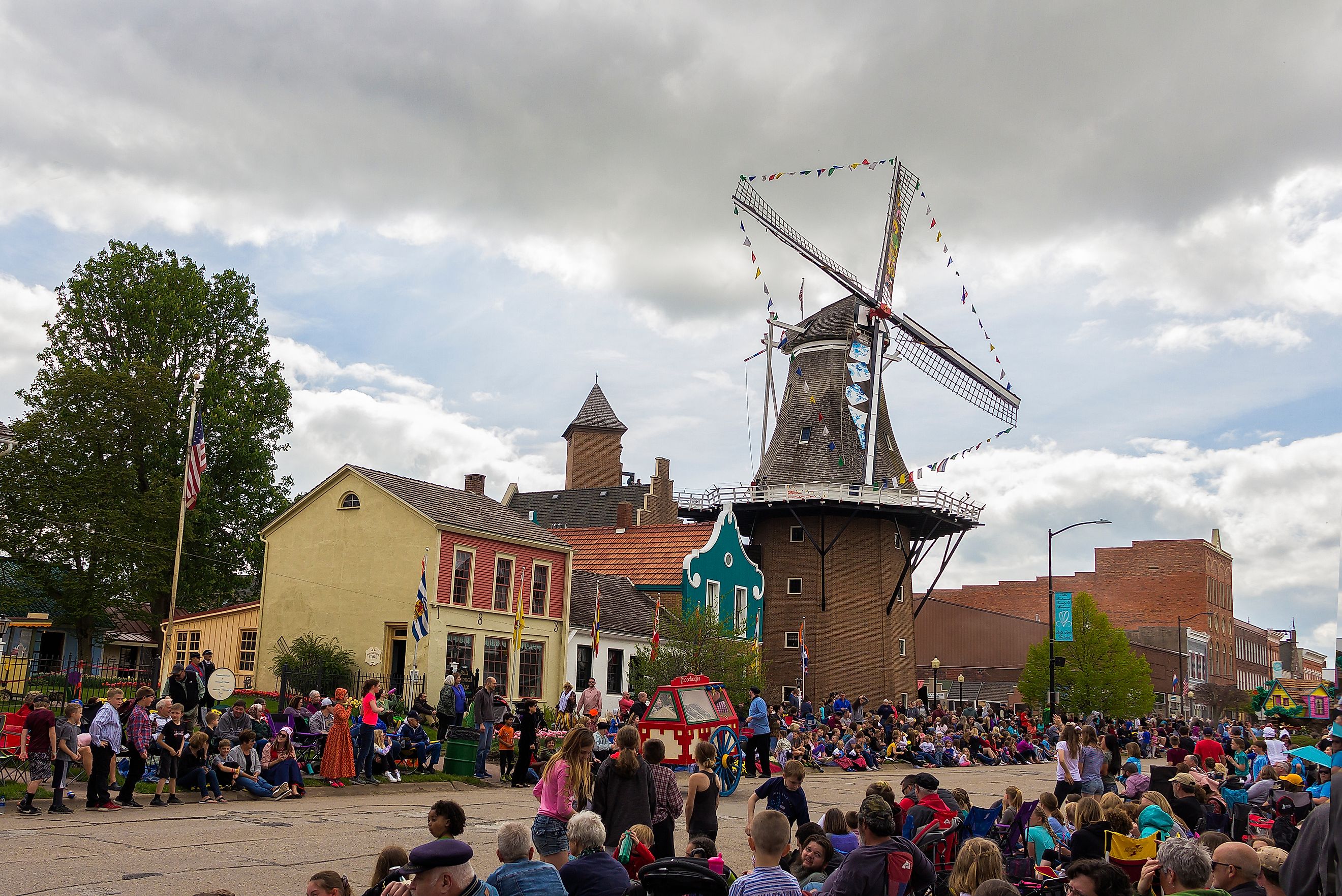 Tulip Time Festival Parade in Pella, Iowa, featuring participants in traditional Dutch attire celebrating the town's Dutch heritage. Editorial credit: yosmoes815 / Shutterstock.com