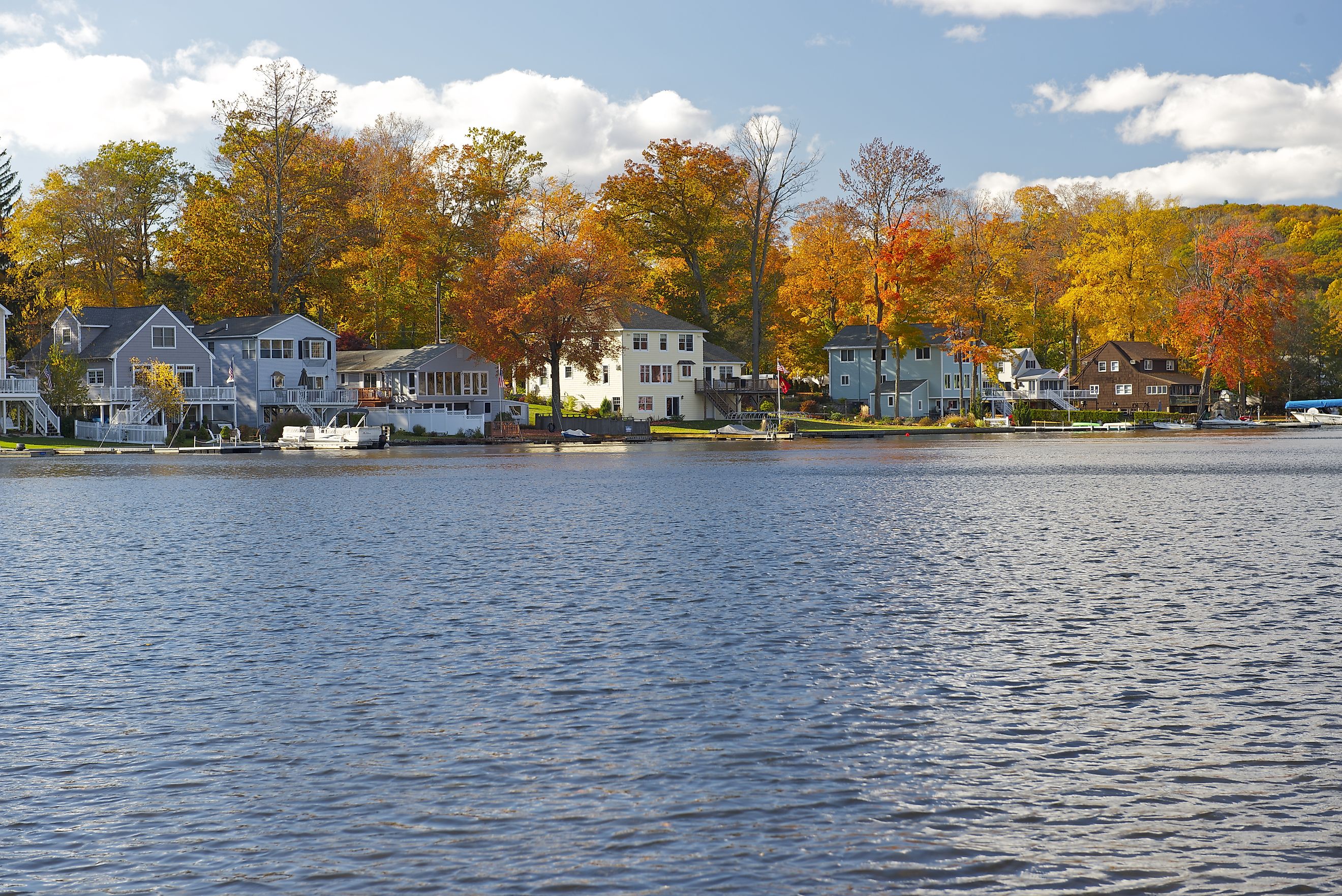 Waterfront homes and fall foliage in the town of Winsted in Winchester, Connecticut.