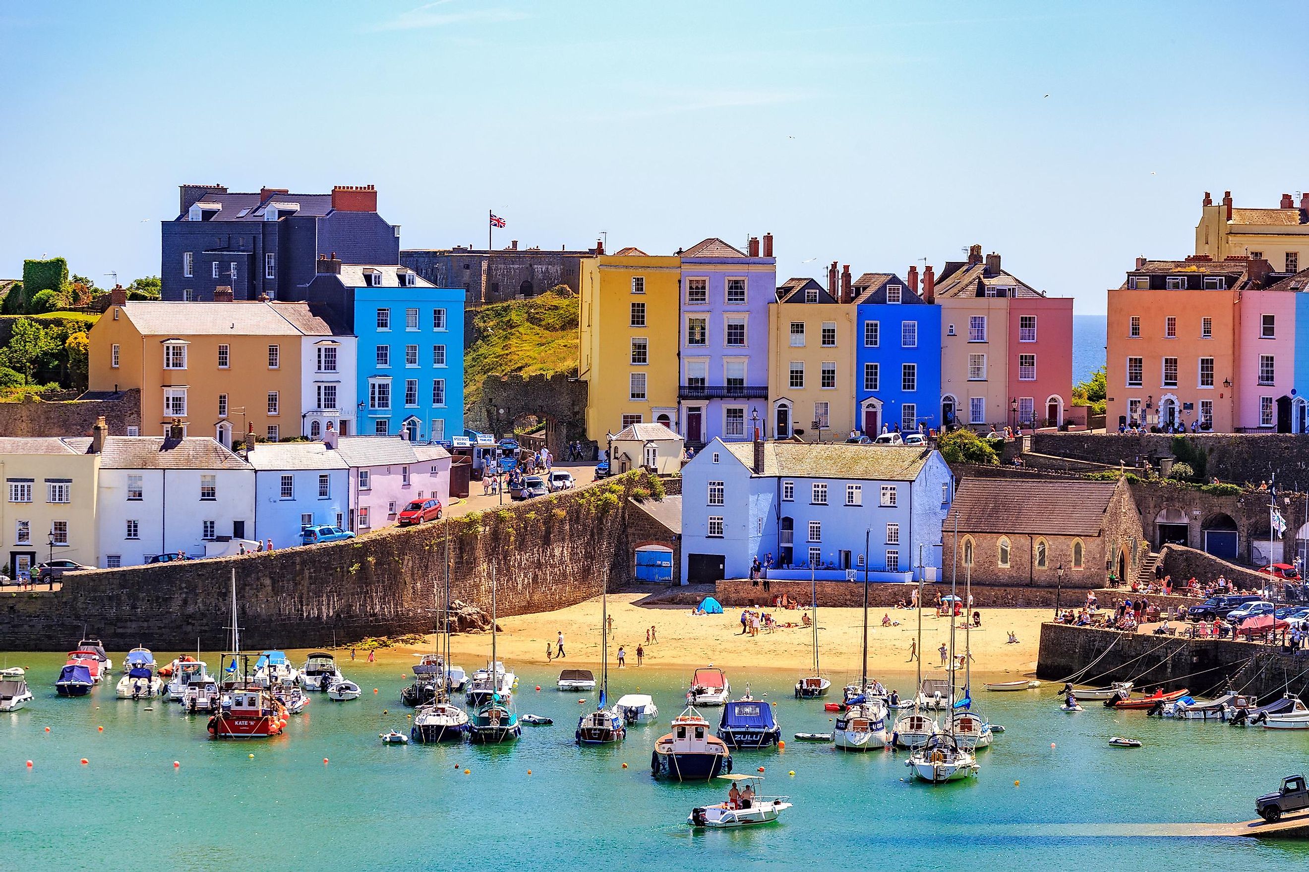 Beautiful summer sunshine and warm weather drew visitors to the beach Tenby, Wales, via Lukasz Pajor / Shutterstock.com