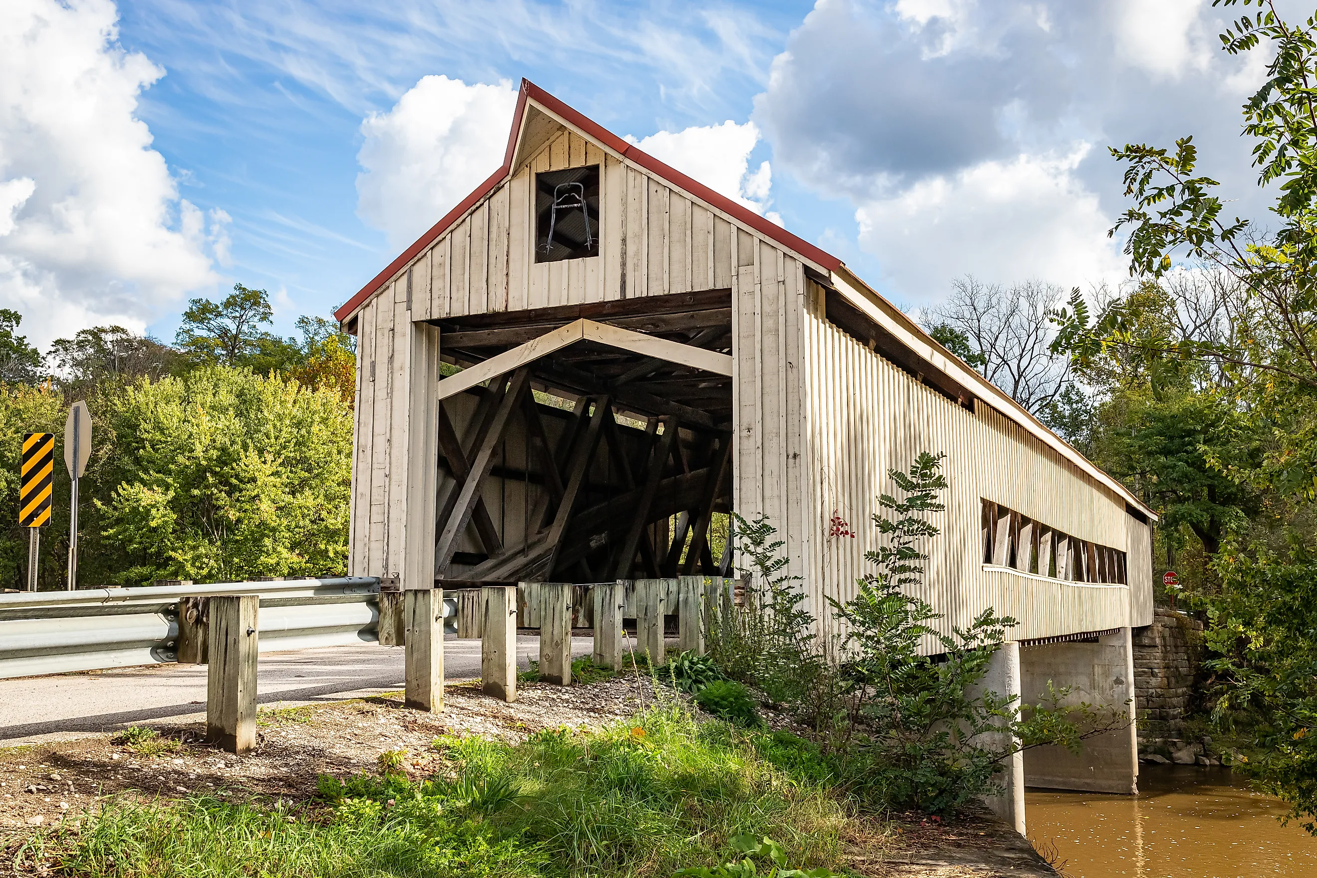 The Mechanicsville Covered Bridge crosses Grand River during the Autumn leaf color change in Ashtabula County, Ohio.