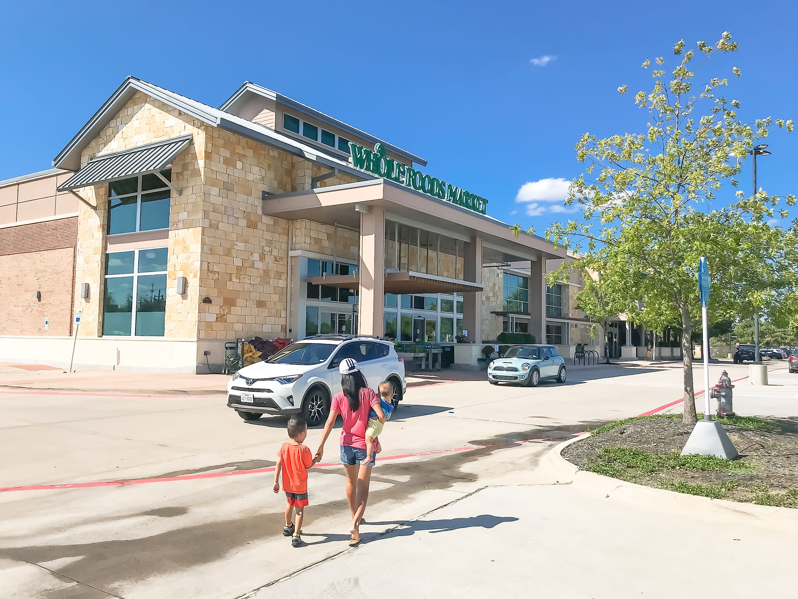 Family members entering Whole Foods in Highland Village, Texas, a suburb of Dallas, known for selling high-quality and natural produce. Editorial credit: Trong Nguyen / Shutterstock.com