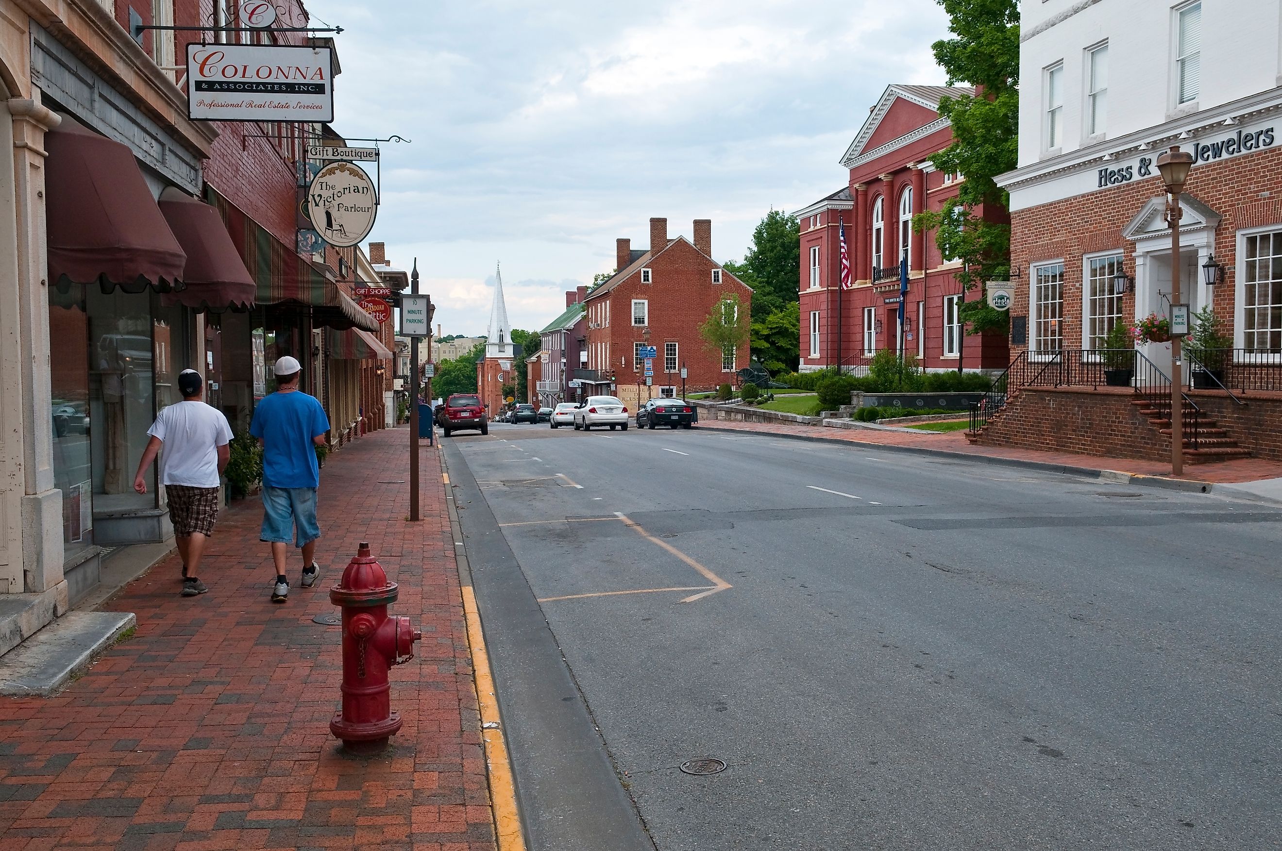 Two young men walk in the business district in historic Lexington, Virginia, via Joel Carillet / iStock.com