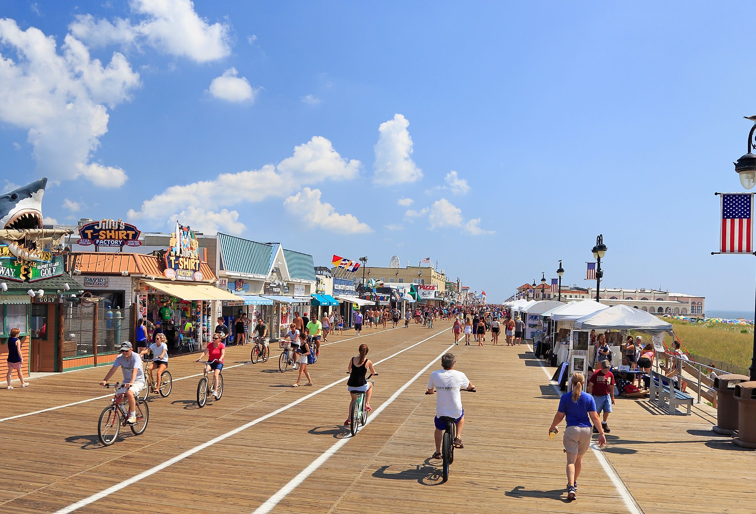 People walking and biking along the boardwalk in Ocean City, New Jersey. Image credit Vlad G via Shutterstock