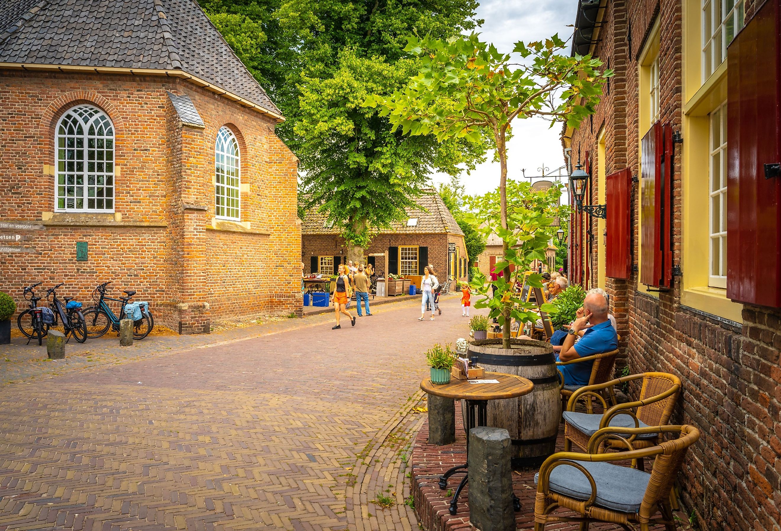 A street view of people sitting at a cafe and others are walking near old architectures in Bronkhorst, Netherlands. Image credit Wirestock Creators via Shutterstock