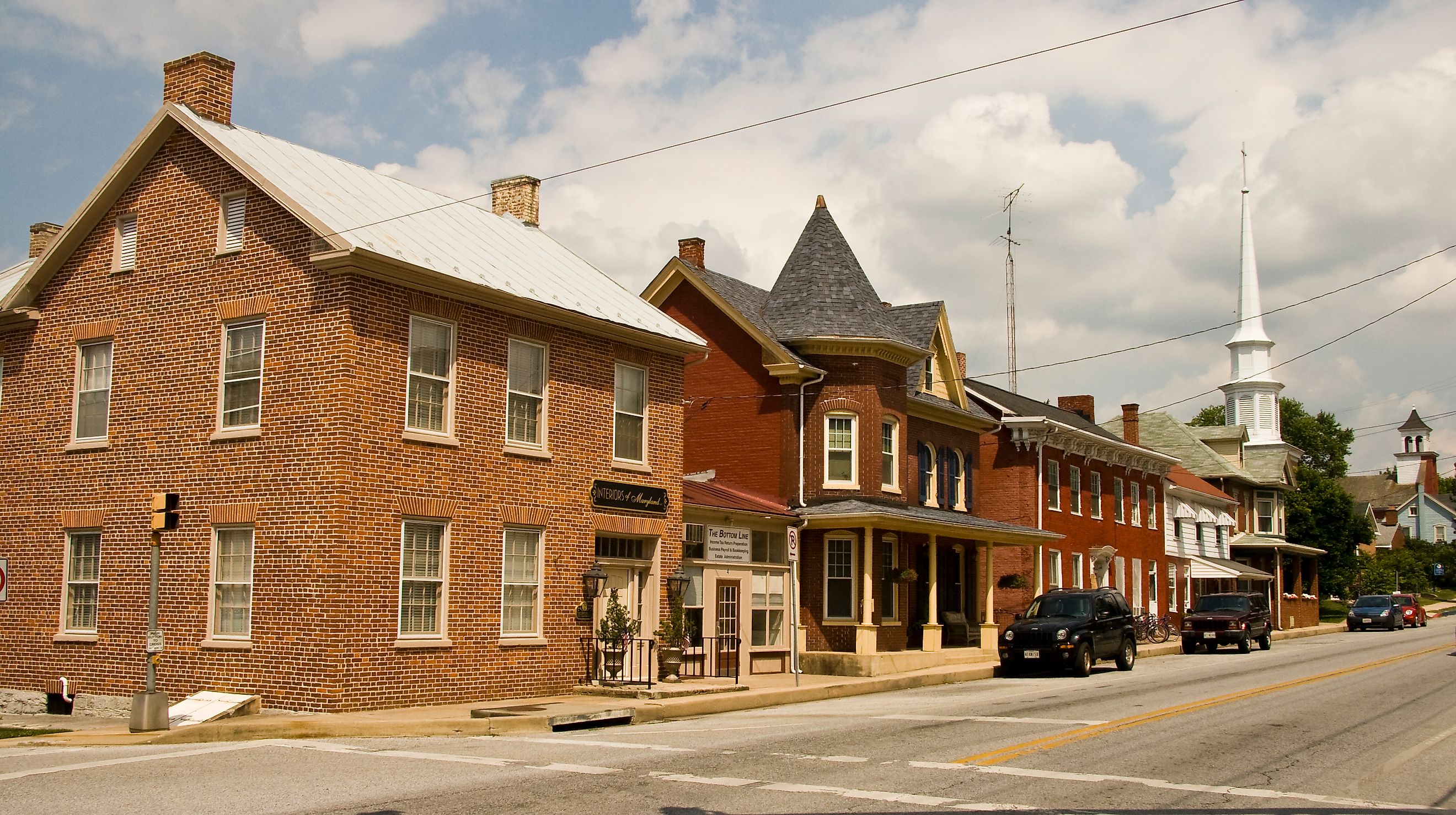 Street view of downtown Funkstown, Maryland, featuring historic brick buildings, small businesses, and tree-lined sidewalks. By Acroterion, CC BY-SA 3.0, https://commons.wikimedia.org/w/index.php?curid=7275466