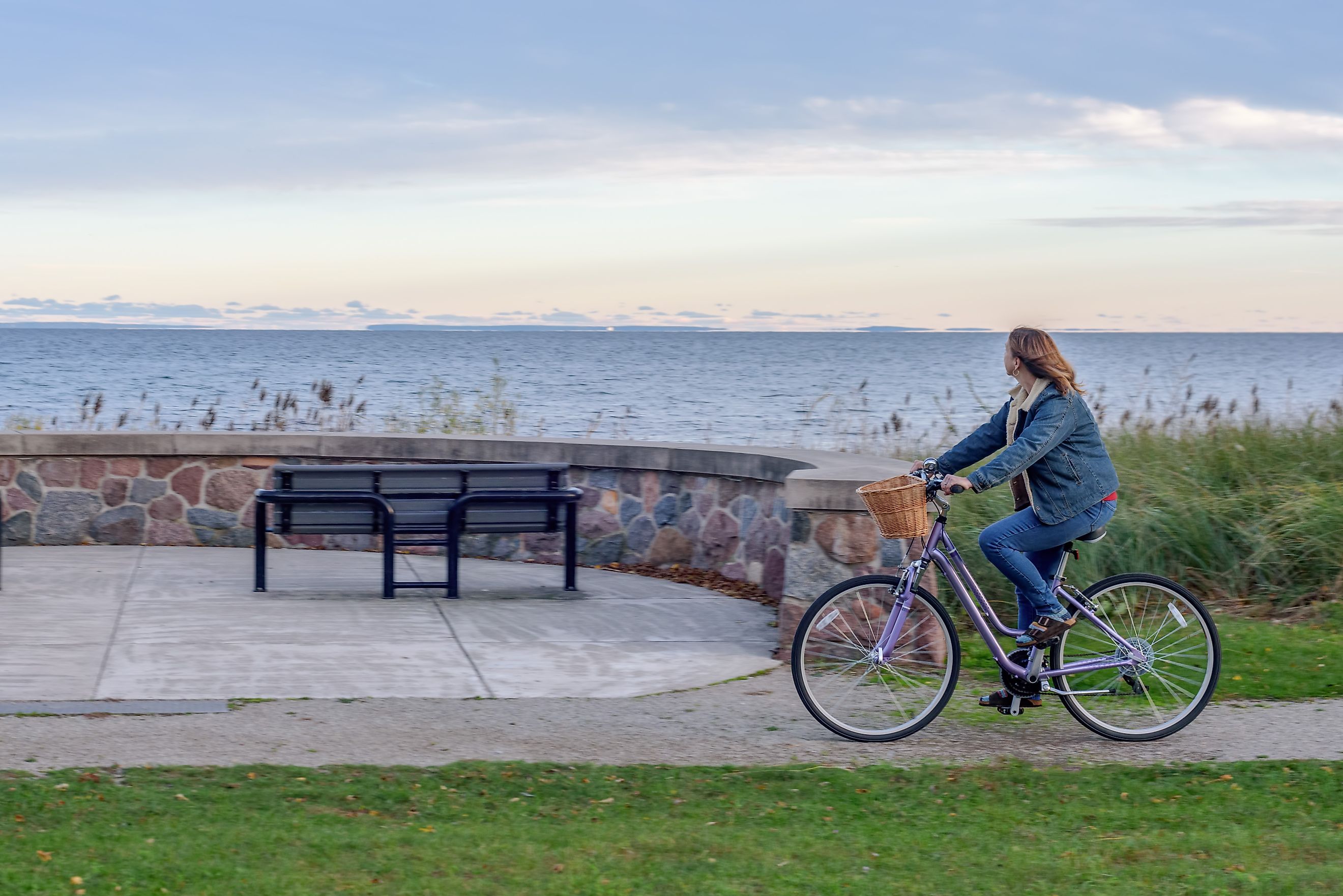 A bicyclist cruises along the Lake Superior shoreline.