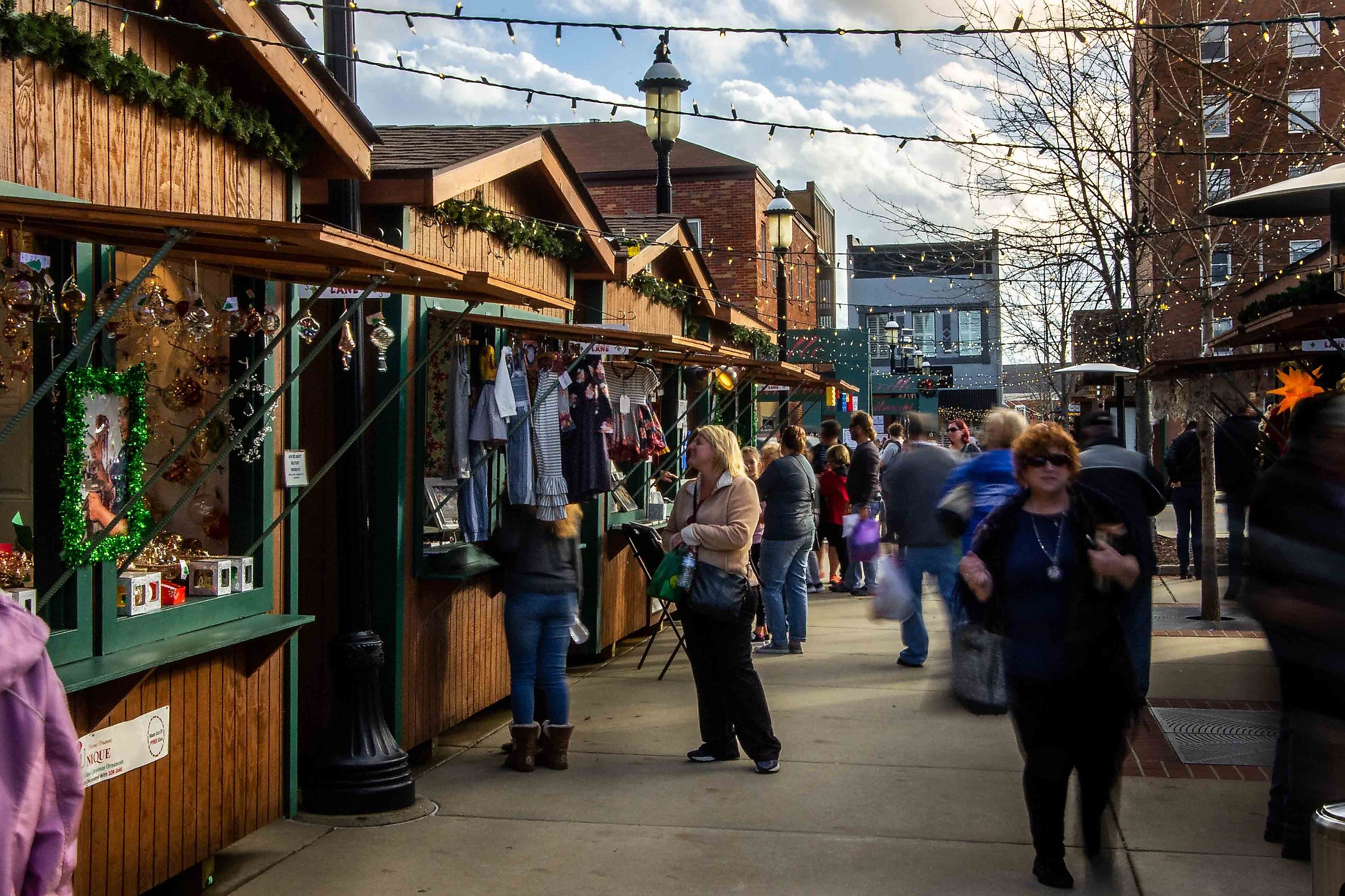 Saint Clair County, IL-December 1, 2018; blurred time exposure of Christmas shoppers moving between vendor cottages at the Belleville Illinois ChriEditorial credit: RozenskiP / Shutterstock.comstkindlmarkt. 