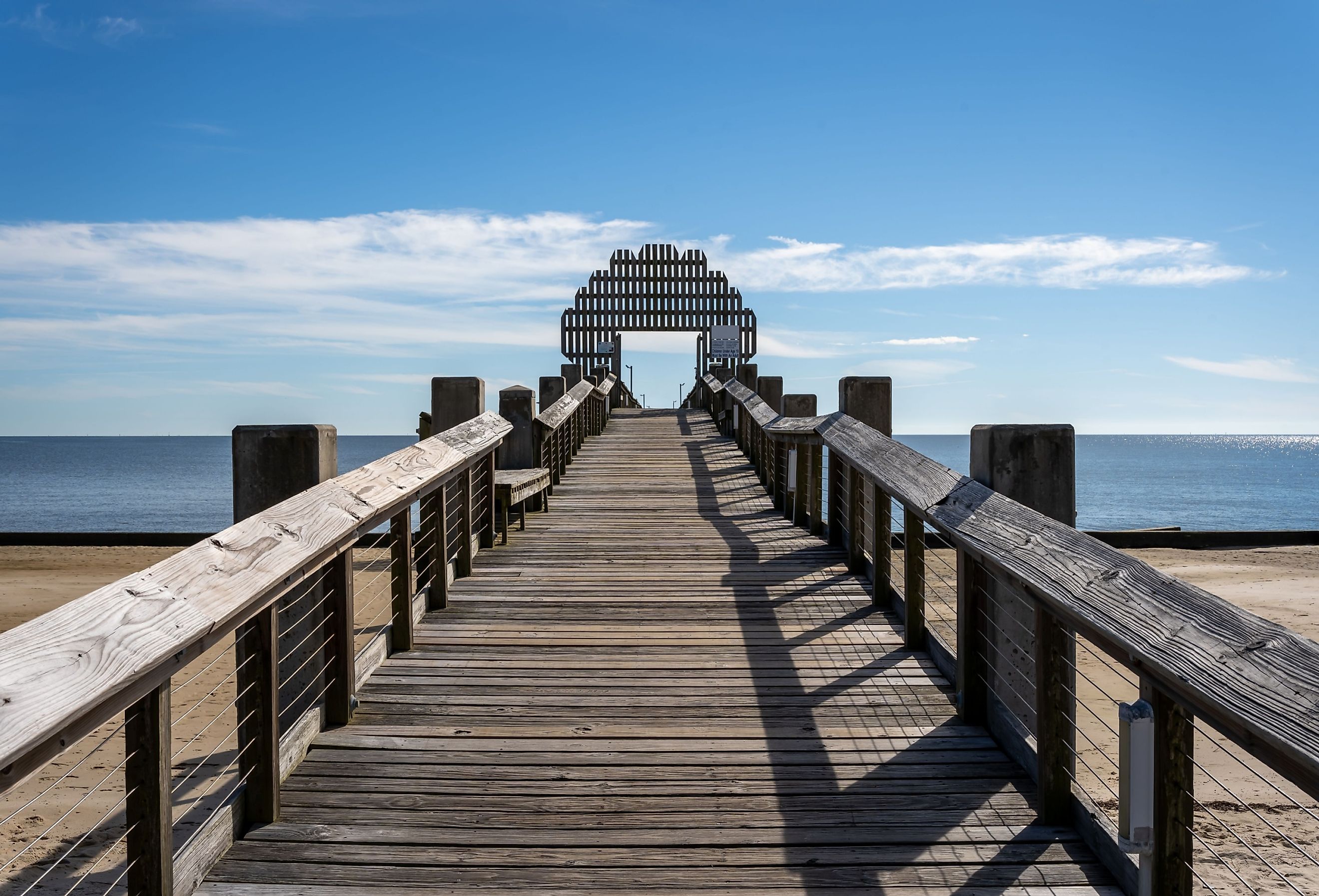 Wooden bridge on the beach in Pascagoula, Mississippi. Image credit Engi Caribe via Shutterstock.